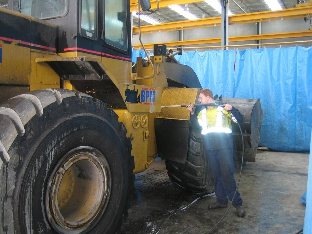 Buckley's mechanic servicing a wheel loader in the workshop